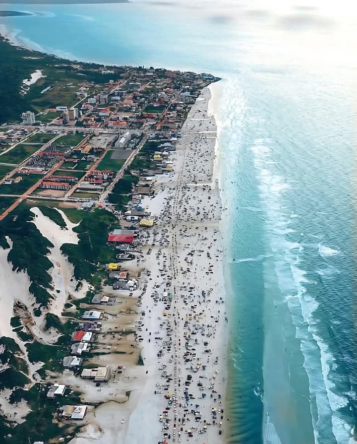 Guia Completo: Onde Ficar em Salinas e Curtir a Praia do Atalaia Vista panorâmica da Praia do Atalaia em Salinas, Pará, com sua icônica areia branca e infraestrutura de barracas à beira-mar, sendo a melhor localização para quem busca onde ficar em Salinópolis com fácil acesso às águas mornas e dunas.